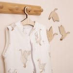 Happy Goose sleeping bag on a hanger beside flying goose wall decorations