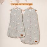 Two olive Happy Goose Olive sleeping bags with goose print on a wooden rack