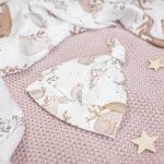 Close-up of the Forest Friends baby hat with a woodland animal print