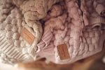 Fema bamboo blankets in beige and misty rose laid side by side with their tags