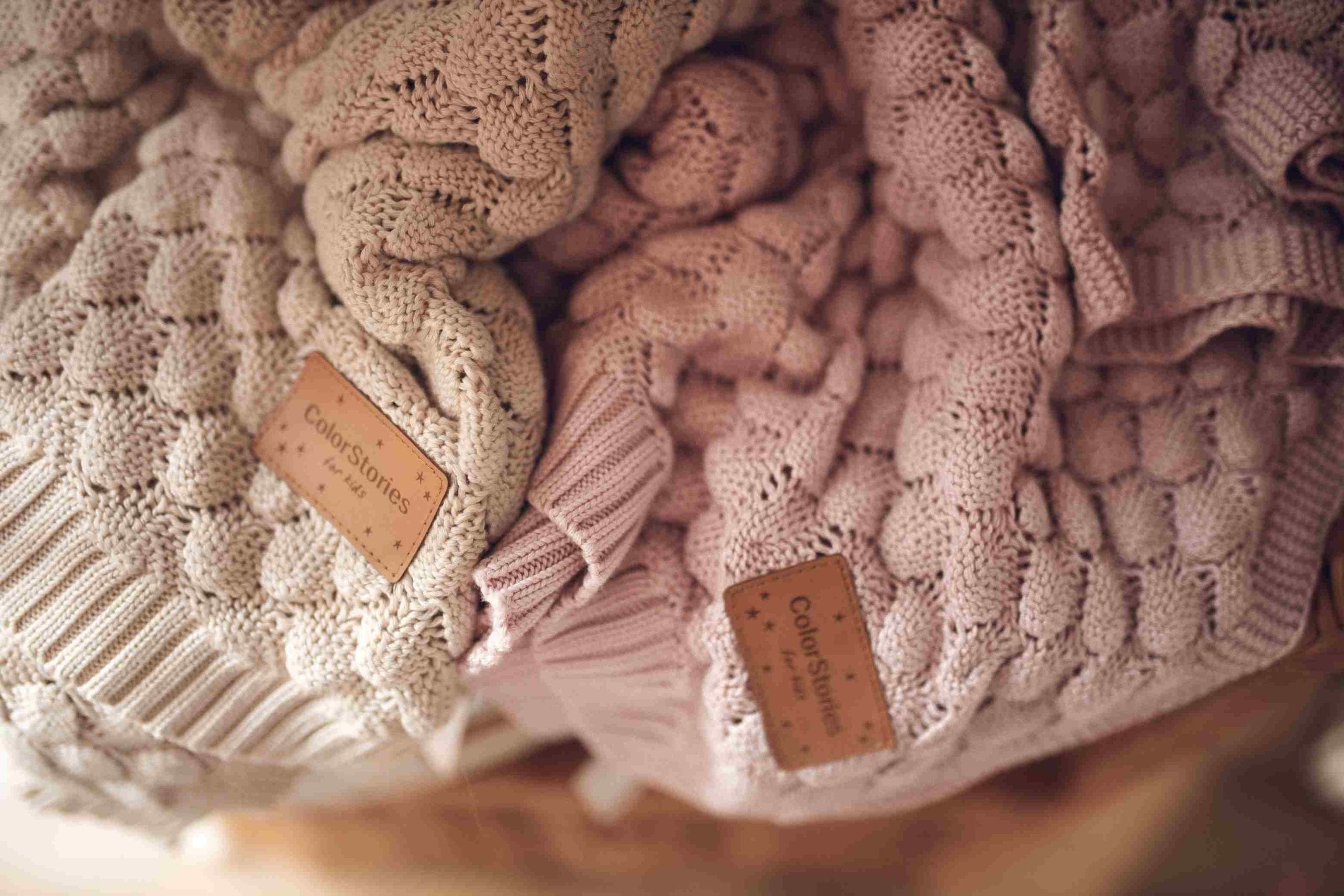 Fema bamboo blankets in beige and misty rose laid side by side with their tags