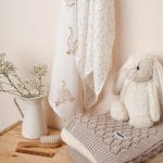 Happy Goose bamboo muslin cloths with geese and dots next to a plush bunny