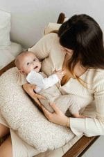 Uśmiechnięte niemowlę oparte o poduszkę do karmienia Herbs - ujęcie z góry