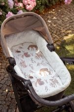 Forest Friends pram fitted sheet with deer and foxes in a pram in the garden