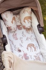 Forest Friends fitted sheet and butterfly pillow with deer in a pram carrycot
