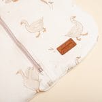 Close-up of the bottom of the Happy Goose sleeping bag - zip, goose print and leather label