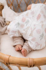 Baby's feet in the Bunny sleeping bag with legs with bunny and pink flower print